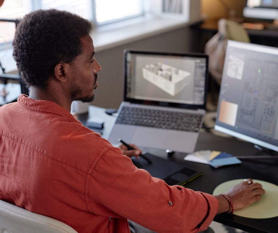 A person working on a laptop on CAD.